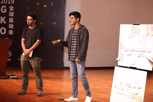 Raj speaking on stage