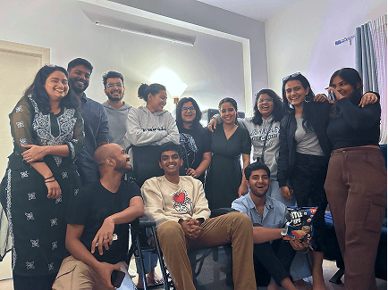 Raj with a team indoors